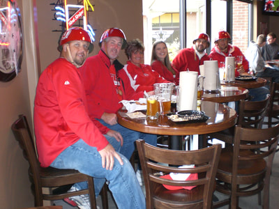 Utah Utes fans eating wings during football game.